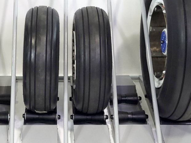 Full contact adjustable rubber rollers cradle the aircraft tires for maximum support.