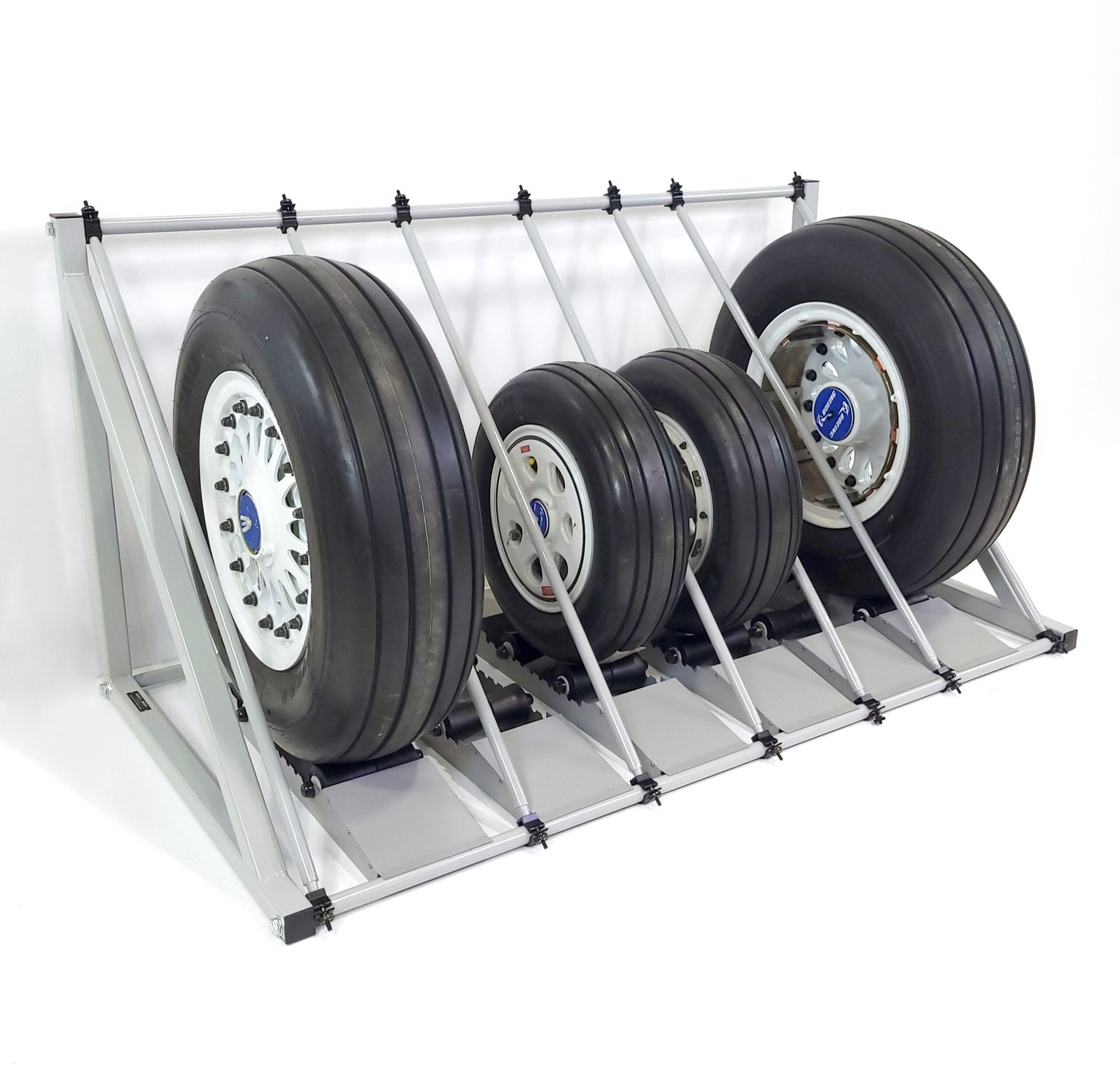 Aircraft wheels and tires on an adjustable GSE storage rack.