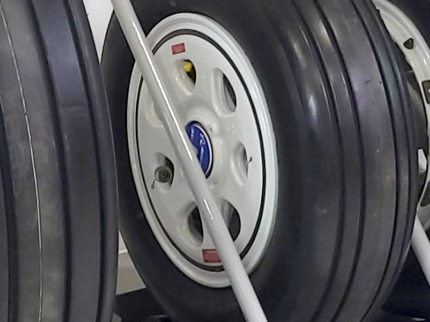 Tire rack support rods have pvc tube covers to protect wheels and sidewalls.